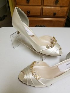 "THIS LISTING IS FOR: US Size 8W Ivory, as shown in pics is ready to ship; HEEL: 1 3/4\" INSIDE LENGHT: 9 3/4\" MEASURE YOUR FEET LENGHT TO ENSURE FIT, FINAL SALE! Wedding Peep toes satin shoes! Hand embellished with a beautiful set of Crystals brooches Please look at the pictures for details! Heel hight in the picture is: 1 3/4'' inches, OTHER SIZES AVAILABLE: COLORS OF SHOES: WHITE, IVORY, OFF-WHITE, CHAMPAGNE COLORS OF JEWELRY: GOLD, OR SILVER To order color samples: www.etsy.com/listing/1297 Elegant Gold Low Heel Wedding Shoes, Classic Gold Heels For Wedding, Elegant Cream Kitten Heels For Wedding, Gold Low Heel Fitted Wedding Shoes, Gold Fitted Low Heel Wedding Shoes, Gold Round Toe Kitten Heels, Elegant Gold Fitted Kitten Heels, Luxury Wedding Kitten Heels With 4-inch Heel, Gold Kitten Heels With 4-inch Heel For Formal Occasions