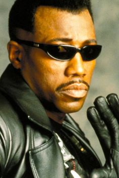 a man in black leather jacket and sunglasses