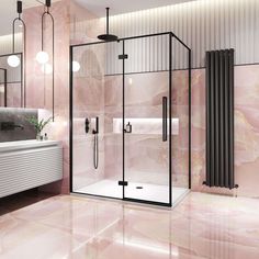 a bathroom with pink marble walls and flooring, including a walk - in shower