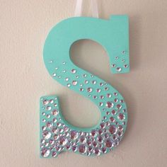 the letter s is decorated with sequins and beads