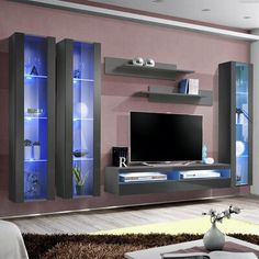 a modern living room with purple walls and black entertainment center on the wall, bookshelf in the middle