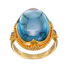 A beautiful brilliant blue 14 x 17 mm cabochon Brazilian Minas Gerias aquamarine is set in a signature Steven Battelle "4 point bezel with jawan" handcrafted 22K Etruscan style gold mount with two 1,8 mm VS1 diamonds on the side shanks, all in matte-finish. An absolute top grade stone, this is one of the finest cabochon aquamarines we've handled. We haven't seen similar stones in the last few gem shows. This ring is currently sized 6.5. It is resizable. Wow! Cabochon Gemstones In 14k Gold Fine Jewelry, Yellow Gold Gemstone Cabochons Fine Jewelry, Luxury Yellow Gold Cabochon Gemstones, Luxury Yellow Gold Gemstone Cabochon, Aquamarine Cabochon, 22k Gold Ring, Gold For Sale, Sapphire Cocktail Ring, Vs1 Diamond