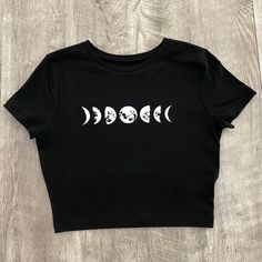 Phases Of The Moon Fitted Crop Top Crop Top Is Very Comfortable And Has High Quality Iron On Vinyl For The Design. Materials: 57% Cotton 38% Recycled Polyester 5% Spandex Care Instructions: Flip Inside Out Then You Can Machine Wash And Lay Flat To Dry Or Use Low Heat In Dryer. Cheap Edgy White Crop Top, Cheap Fitted Grunge Tank Top, Cheap Edgy Crop Top For Spring, Cute Cropped T-shirt, Cheap Gray Stretchy Crop Top, Cute Cropped Tops, Fitted Black Tops With Moon Print, Fitted Moon Print Tops For Summer, Black Summer Top With Moon Print