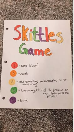 a paper sign that says skittles game on the side of a carpeted floor