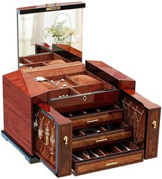 an open wooden jewelry box sitting on top of a table