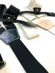 Perfect for formal events and absolutely stunning!We can substitute the black leather with any other of our top grain veg-tan leather colors.We also offer our formal black tie suspenders with our trademark natural veg tan back patch in addition to our magnetic clasps or button on attachments in another color besides black. Color options included in the last photo.All Stratton Suspender strap sets can be used with our vintage leather button on attachments or with our MOST popular, beautiful yet shockingly functional, leather clasp sets. A truly unique way to stand out with class! Guaranteed to not come off. More than that, the modularity of Stratton Suspenders allows you to interchange different straps adding an entirely new dimension to men’s style. One set of Stratton Suspenders guarantee White And Black Tuxedo, Leather Colors, Black Tuxedo, Veg Tan Leather, Linen Set, Back Patch, Suspenders, Braces, Black Tie