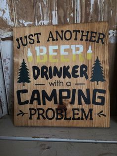 a wooden sign that says just another beer drinker with a camping problem