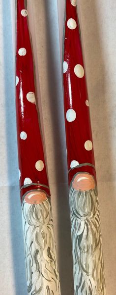 two red and white toothbrushes sitting on top of each other