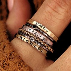 GORGEOUS stacking name rings set, including three personalized name rings and spacer rings. This mixed metal set is a great gift for mom or grandma! THIS STACKABLE NAME RING SET INCLUDES ALL OF THE RINGS IN THE FIRST PHOTO -a 2 mm name ring in lowercase cursive -a 1mm black cz ring -a 2mm name ring in uppercase thin font -a beaded spacer ring -a 1 mm clear cz ring -a 2mm name ring in uppercase bold block font These are separate rings and can be put in any order Six total rings... We recommend si Personalized Stackable Rings, Stackable Name Rings, Grandmother Jewelry, Stacked Rings, Rings Stacking, Necklace Combo, Ring Cuts, Ring Spacer, Name Ring