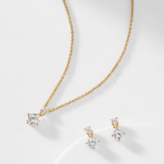 ABOUT THE PRODUCT A simple and chic way to add just the right amount of sparkle to your look, this delightful necklace and earring set features dazzling cubic zirconia stones.  A great bridal party gift, this set can be dressed up or down and will be treasured for years to come. Metal: BrassPlating: 18KT Gold or Rhodiu Gold Cubic Zirconia Bridal Necklace For Party, Dainty Cubic Zirconia Solitaire Necklace For Formal Occasions, Classic Cubic Zirconia Necklaces With Matching Earrings, Classic Solitaire Necklace With Sparkling Cubic Zirconia, Classic Solitaire Necklace With Sparkling Stones For Wedding, Classic Solitaire Necklace For Wedding, Classic Wedding Solitaire Necklace With Sparkling Stones, Fine Jewelry Cubic Zirconia Necklace With Matching Earrings, Classic Cubic Zirconia Necklace With Matching Earrings