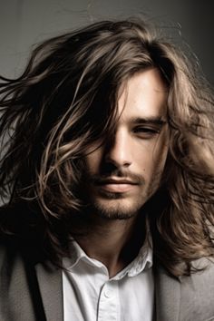 The messy long hair with a bedhead look is an effortless and low-maintenance style that suits men with long hair. It embraces the texture requiring minimal effort to achieve that just rolled-out-of-bed appearance. Click here to check out more irresistible long hairstyles for men. Messy Long Hair, Vintage Wedding Suits, Men With Long Hair, Long Hair Beard, Beard Style, Suits Men