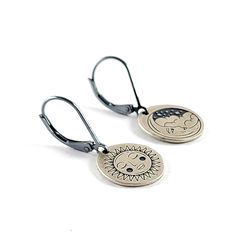 Sterling & 90% Coin Silver Mystic Tattoo Engraved Earrings. Choose from your favorite design, you can even mix and match! These earrings measure about 1" long. These earrings are made using 90% silver coin punch outs leftover from making our coin rings. The lever back ear wires are sterling silver with an antique finish. Stand out with these adorable earrings! *IMPORTANT* If you would like to add custom engraving to the back please leave a note at checkout including your personalizations. For cu Mystic Tattoo, Quarter Ring, Flatware Jewelry, Coin Rings, Engraved Earrings, Half Dollar Coin, Coin Bracelet, Coin Earrings, Jewelry Care Instructions