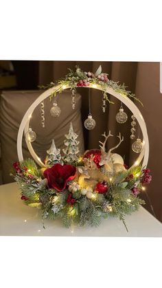 a christmas centerpiece with ornaments and lights on it's sides, including an ornament