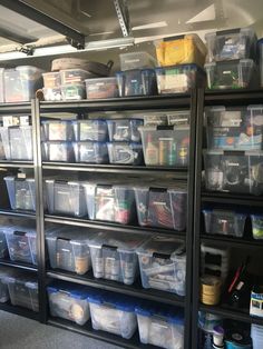 the shelves are filled with many different types of plastic containers and bins for storage