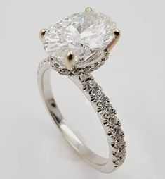 Introducing an elegant 18k White Gold Engagement Ring, adorned with a breathtaking oval brilliant-cut lab-grown diamond at its center. Weighing 1.84ct, the diamond boasts VS clarity and F color, radiating brilliance and beauty. Surrounding the centerpiece are 34 small round brilliant diamonds, totaling 0.37ct, adding extra sparkle and charm to the ring.Crafted with precision, this exquisite ring weighs 3.5g and comes in a size 6.75. Additionally, it includes complimentary sizing options, allowing for adjustments up or down by 1.5 sizes to ensure a perfect fit.Embrace the timeless elegance and exceptional quality of this engagement ring, a symbol of everlasting love and commitment.For further inquiries, additional information, or to explore more exquisite pieces like this, we invite you to Dazzling Oval Lab Grown Diamond Ring, Oval Lab Grown Diamond Ring In Diamond White, Oval White Moissanite Diamond Ring, White Oval Lab-grown Diamond Ring, Oval Moissanite Diamond Ring With Vvs Clarity, Oval Lab Grown Diamond Ring Fine Jewelry, Oval Brilliant Cut Diamond Ring, Oval Diamond White Halo Ring, Oval Halo Ring In Diamond White