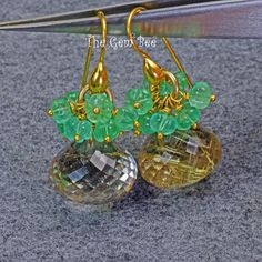 DESCRIPTION: Thank you for coming in! Spectacular 18K solid yellow gold earrings with fine 9.05 carat gem emerald melons and 32.7 carats fine golden rutilated quartz onions! It looks much much nicer in person! You'll get the pair of earrings you see! DIMENSION: 1.25 Inch Total Length. 15mm rutilate quartz, 4.5mm-5mm emerald. MATERIAL: 18K Solid Yellow Gold, Natural Emerald, Golden Rutilated Quartz. Elegant Green Citrine Jewelry, Fine Green Citrine Jewelry, Formal Green Citrine Jewelry, Green Citrine Round Jewelry, Green Round Citrine Jewelry, Elegant Green Briolette Gemstones, Green Citrine Jewelry With Gemstone Accents, Handmade Elegant Emerald Gemstones, Elegant Handmade Citrine Gemstones