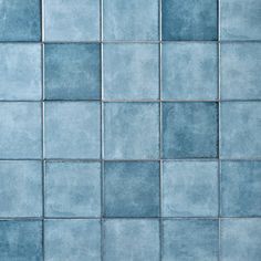 a blue tiled wall with no one in it