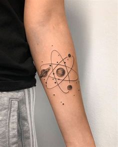 a person with a tattoo on their arm that has an image of the planets and stars