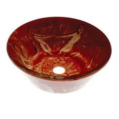 a red glass sink sitting on top of a black counter