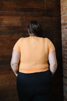 Feel the summer vibes with Jessa In Marigold! This cheerful and lightweight orange top features a flattering ribbed texture, short sleeves, and a fitted style for a perfect fit. Stay stylish and comfortable all day long in this must-have piece. This top is paired with the Marigold Maxi Skirt. Fits true to size. Model is wearing a small and is 5'3". Plus model is wearing an XL and is 5'7". The color in the pic shown with the Marigold Maxi Skirt is more color accurate. Size Chart Length Bust S 21. Top Naranja, Maxi Skirt Fits, Tiered Dresses, Plus Model, Hanging Fabric, Spring Fits, Orange Top, Fitted Style, Skirt Fits