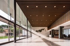 the inside of a large building with glass walls and floor to ceiling windows on both sides