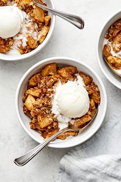 two bowls filled with apple crisp and ice cream