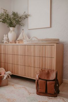 a baby's room with a crib and dresser