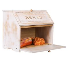 a wooden bread box with two loaves of bread in it and the word bread written on top