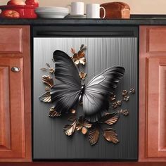 a black and gold butterfly is on the side of a refrigerator