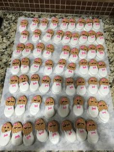 a table topped with lots of cupcakes covered in white frosting