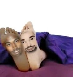 two people with fake faces are laying on a bed