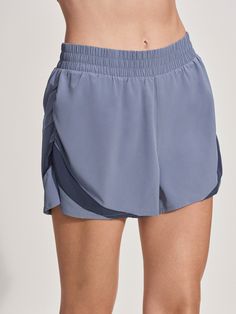 These shorts feature an internal brief for support, a back waistband pocket for essentials, and fluted side hems for flexibility. Made from sweat-wicking, stretch woven fabric with contrast panels, they are designed to keep you comfortable during any activity. Sporty Running Shorts With Contoured Waistband, Stretch Jogging Shorts, Athleisure Nylon Shorts With Contoured Waistband, Athleisure Athletic Shorts With Elastic Side Panels, Athleisure Shorts With Elastic Side Panels For Workout, Athleisure Workout Shorts With Elastic Side Panels, Sporty Stretch Athletic Shorts With Comfort Waistband, Workout Activewear With Elastic Side Panels, Sports Bottoms With Elastic Side Panels In Short Length