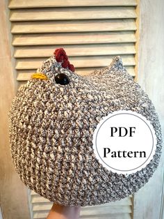 a person holding a crocheted chicken pillow over their head with the text, free pattern