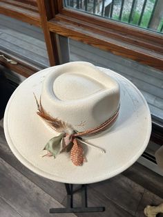 Discover the rugged charm of our Burned Western Hat. This unique, handcrafted cowboy hat features a distressed look, giving it a vintage, well-worn appeal perfect for Western enthusiasts and fashion-forward individuals. Features: Handcrafted Design: Each hat is meticulously burned and distressed to achieve a one-of-a-kind look. Premium Materials: Made from high-quality materials for durability and comfort. Unique Aesthetic: The burned finish adds a distinctive vintage style that sets it apart. B Custom White Fedora For Country Events, Adjustable Cream Hat For Western-themed Events, White Fedora With Flat Crown For Country Events, Rustic Adjustable Felt Hat For Kentucky Derby, Rustic Fedora Hat For Kentucky Derby, Western Cream Sun Hat For Rodeo, Western Style Cream Sun Hat For Rodeo, Country Style Cream Hat Bands For Western-themed Events, Cream Western Panama Hat For Kentucky Derby