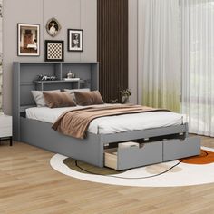 a bed sitting on top of a wooden floor next to a white dresser under a window