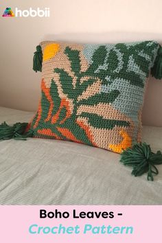 a crocheted pillow with tassels on it and the text boho leaves - crochet pattern