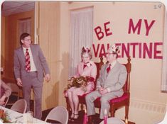 an old photo of two men and a woman dressed up for valentine's day