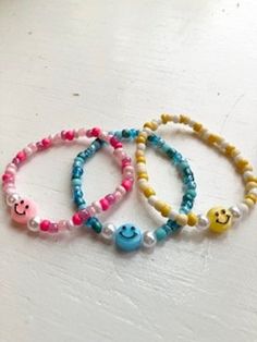 SMILEY FACE BRACELETS These bracelets make great gifts for all ages - with three different options of colors and a cute smiley face charm in the middle. Please take into consideration that all bracelets are 6.5", and I do not offer custom sizes. All bracelets are closed with a non-adjustable tie. WARNINGS Due to the material of the beads, I would recommend keeping bracelet dry, away from water or chemicals. The coated beads can lose their color with too much wear and tear. Although these bracelets are made with a stretchy cord, please refrain from stretching them too hard, for I do not offer returns if they break in your possession. Cute Smiley Face Bracelets For Friendship, Fun White Charm Bracelet For Friendship, White Fun Charm Bracelet For Friendship, Adjustable Playful Charm Bracelet, White Fun Charm Bracelet, Cute Smiley Face Bracelets For Gift, Cute Smiley Face Bracelets As Gift, Playful Smiley Face Bracelets For Everyday Wear, Cute Smiley Face Bracelet For Gift