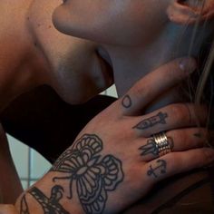 a woman with tattoos on her arm and hand