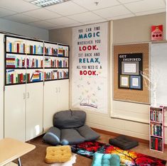 a room with bookshelves, chairs and rugs on the floor in front of it