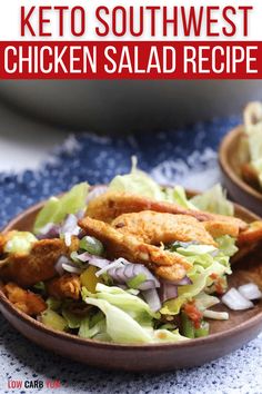 chicken salad with lettuce and onions in a bowl on a blue table cloth