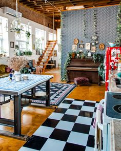 a living room filled with lots of furniture and decor on top of a hard wood floor