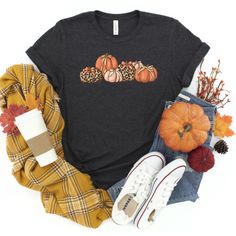 Get in the spirit of the fall with this simple Leopard Coquette Bow Pumpkin graphic tee. Perfect for fall, Thanksgiving, or a day at the pumpkin patch. This cute leopard pumpkin graphic T-shirt design is so adorable for your fall festivities! Our shirts are great for the fall season and would make a great gift.  Are you looking for your new favorite t-shirt? Our graphic tees are custom created specifically for you and made by me not sourced out to a print shop. Select your shirt style, color, an Fall Relaxed Fit Graphic Tee, Graphic Cotton Tee For Fall, Fall Cotton Graphic Tee Shirt, Bow Pumpkin, Retro Coquette, Hey Pumpkin, Pumpkin Graphic, Leopard Pumpkin, Coquette Bows