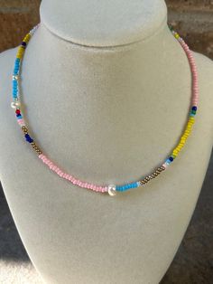 Multicolored seed bead necklace with shades of pink and blues. Accented with freshwater pearls. Pink Pearl Necklace With Tiny Beads, Adjustable Pink Pearl Necklace With Colorful Beads, Bohemian Pearl Beaded Necklaces With Tiny Beads, Pink Pearl Necklace With Colorful Round Beads, Pink Beaded Bohemian Pearl Necklace, Pink Bohemian Beaded Pearl Necklace, Bohemian Pink Beaded Pearl Necklace, Crystal Lake, Seed Bead Necklace