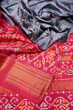 Just the kind of festive vibe that you would like to set - let's do it with the ikat silk. The hand-picked collection with a traditional geometric motif design on the body with ikat weaving work on the pallu and the golden zari border. It also sports an amazing double temple border which makes it unique. Color: A shade of grey and magenta color Technique: Amazing work of traditional tie and dye work on the whole saree with zari work Fabric: Ikat Silk Quality: IndyVogue's Assurance of Silk Mark Certified Multicolor Ikat Print Saree Set, Festive Red Ikat Print Dupatta, Festive Ikat Print Dupatta, Bohemian Multicolor Ikat Print Traditional Wear, Festive Fusion Style Silk Sets, Festive Fusion Silk Sets, Festive Ikat Print Dupatta With Traditional Drape, Festive Ikat Print Dupatta In Traditional Drape, Festive Red Ikat Print Saree