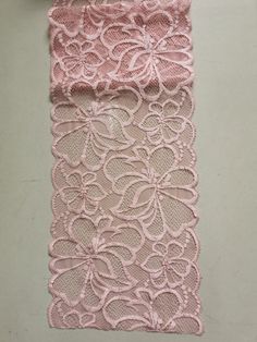 two pieces of pink lace sitting on top of a table