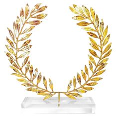 a gold laurel wreath on a clear base