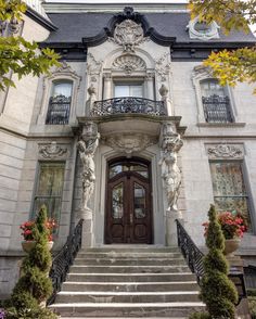 the front entrance to a large house with steps leading up to it