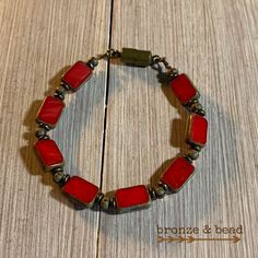 This bracelet is made with 8x12mm Ruby red rectangle Picasso beads with bronze barrel beads. Strung on 17 strand wire. Bronze lobster claw clasp. 6.5 inches. Handmade Rectangular Red Bracelets, Red Metal Beaded Bracelet With Round Beads, Adjustable Rectangular Bronze Jewelry, Red Rectangular Adjustable Jewelry, Red Rectangle, Smoky Topaz, Star Ruby, Green Earrings, Czech Beads