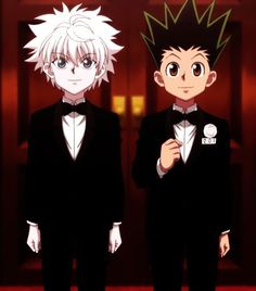 two young men in tuxedos standing next to each other